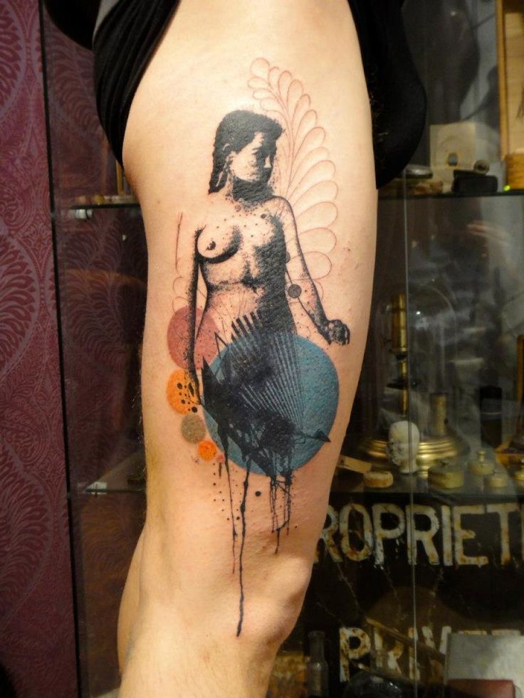 a person with a tattoo on their leg that has an image of a naked woman