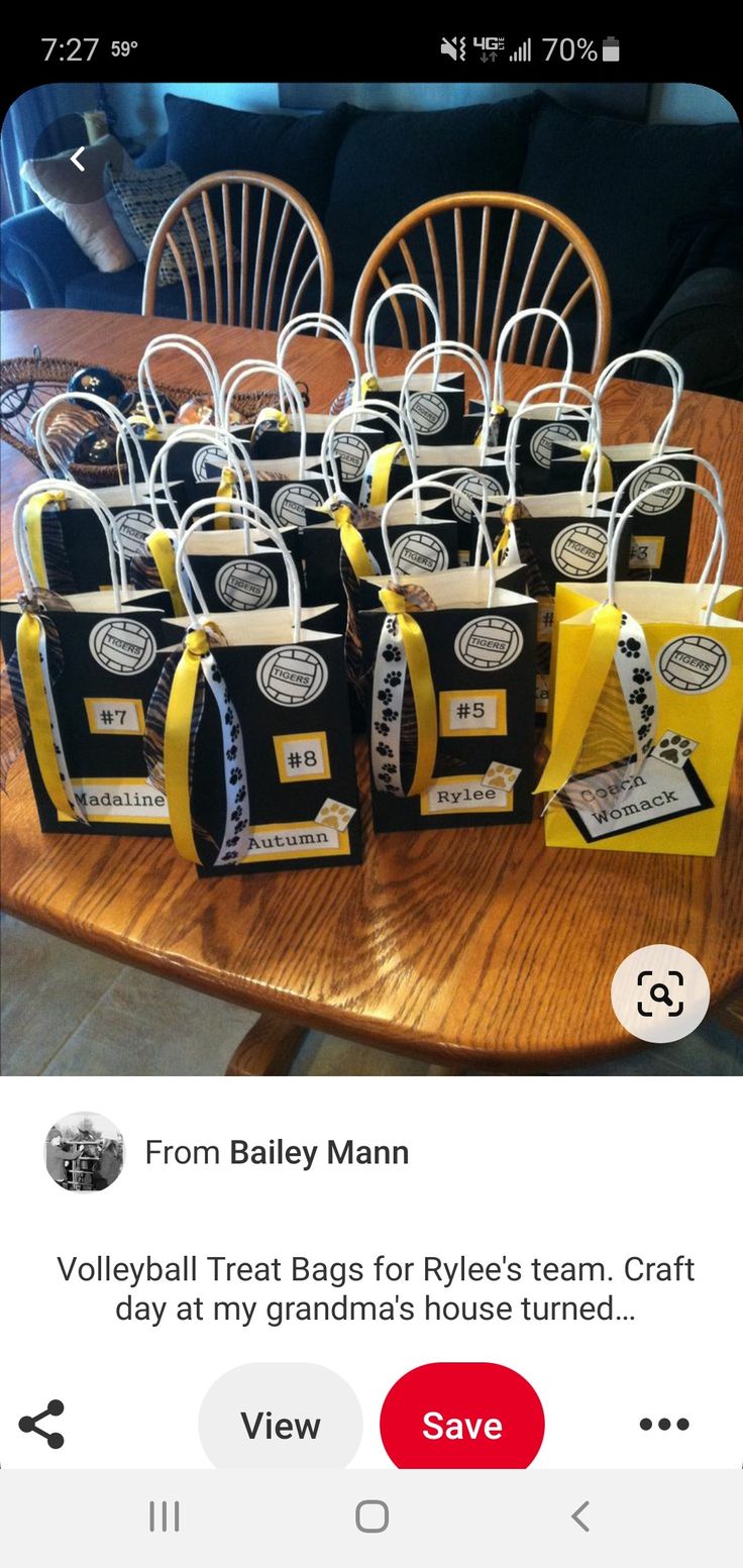 some bags are sitting on a table with yellow ribbons and tags attached to the bags