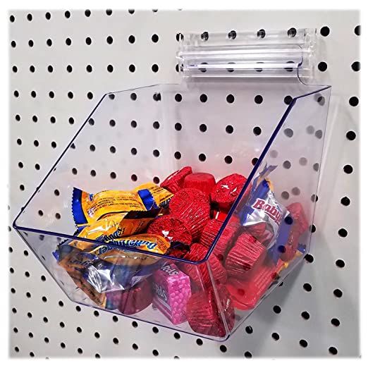 a clear plastic container filled with candy on top of a polka dot tablecloth covered wall