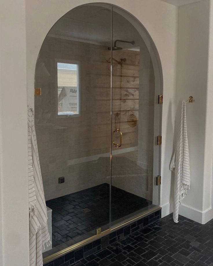 an arched glass shower door in a bathroom