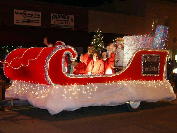 a red and white float with people riding in it