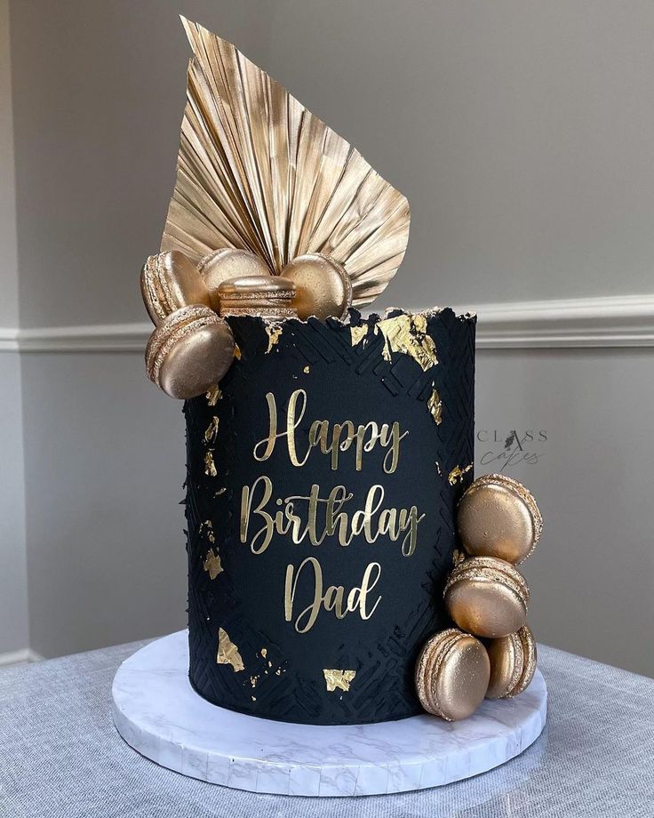 a black and gold birthday cake on a table