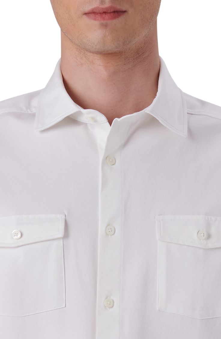 Button-flap pockets sharpen this shirt knit from breathable, eight-way-stretch OoohCotton that resists wrinkles to keep you polished and comfortable. 30" length; 42" chest (size Medium) Spread collar Short sleeves 92% cotton, 8% spandex Machine wash, dry flat Imported Solid Color Collared Shirt With Functional Buttons, Business Casual Shirt With Flap Pockets And Spread Collar, Fitted Collared Shirt With Flap Pockets, Business Casual Button-up Shirt With Flap Pockets, White Cotton Tops With Flap Pockets, White Cotton Top With Flap Pockets, Classic Shirt With Flap Pockets For Business Casual, Collared Tops With Flap Pockets For Business Casual, White Top With Welt Pockets For Business Casual