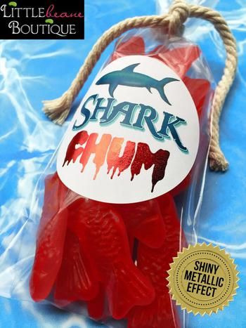 a package of shark gummy bears in plastic wrapper with rope on blue background