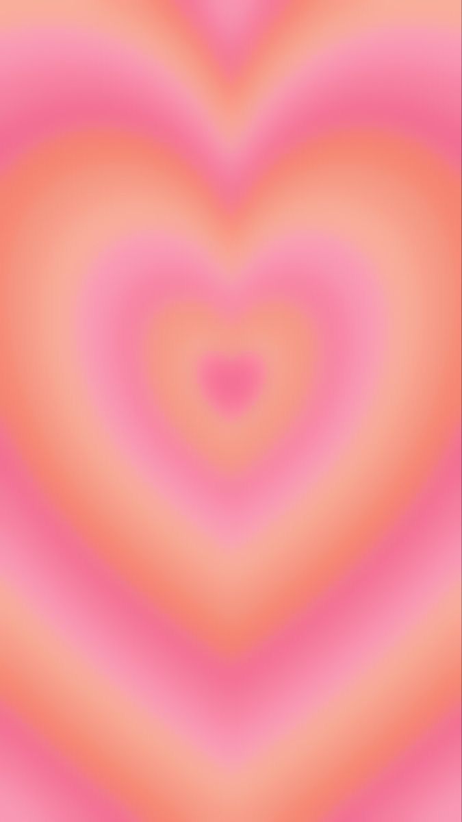 an abstract pink and orange background with a heart shape in the center, as if it were blurred or blurry