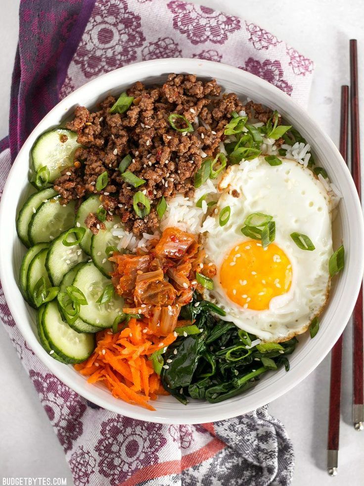 a bowl filled with meat, vegetables and eggs