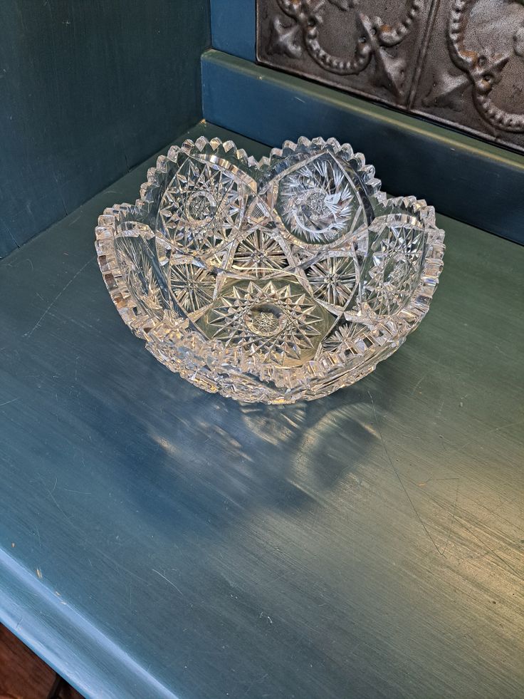 a glass bowl sitting on top of a blue table