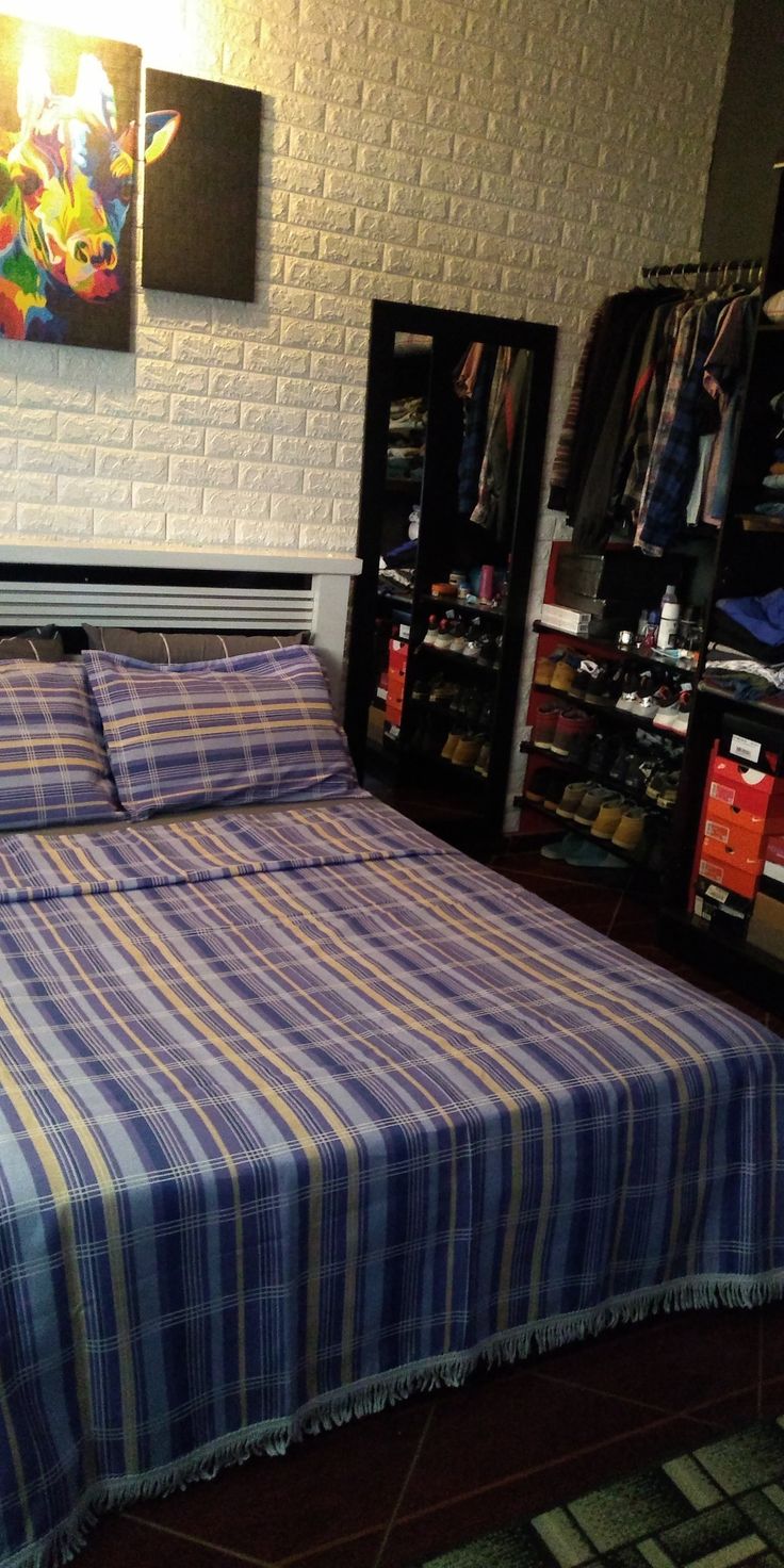 a bed sitting in a bedroom next to a book shelf