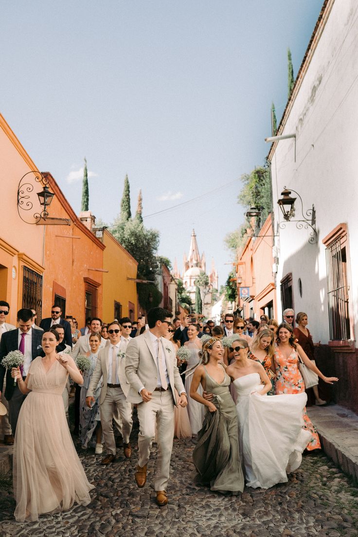 a group of people walking down a street next to each other