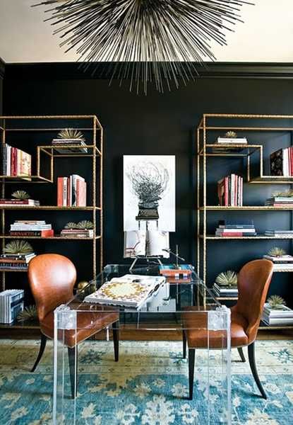 a living room filled with furniture and bookshelves next to a wall mounted book shelf