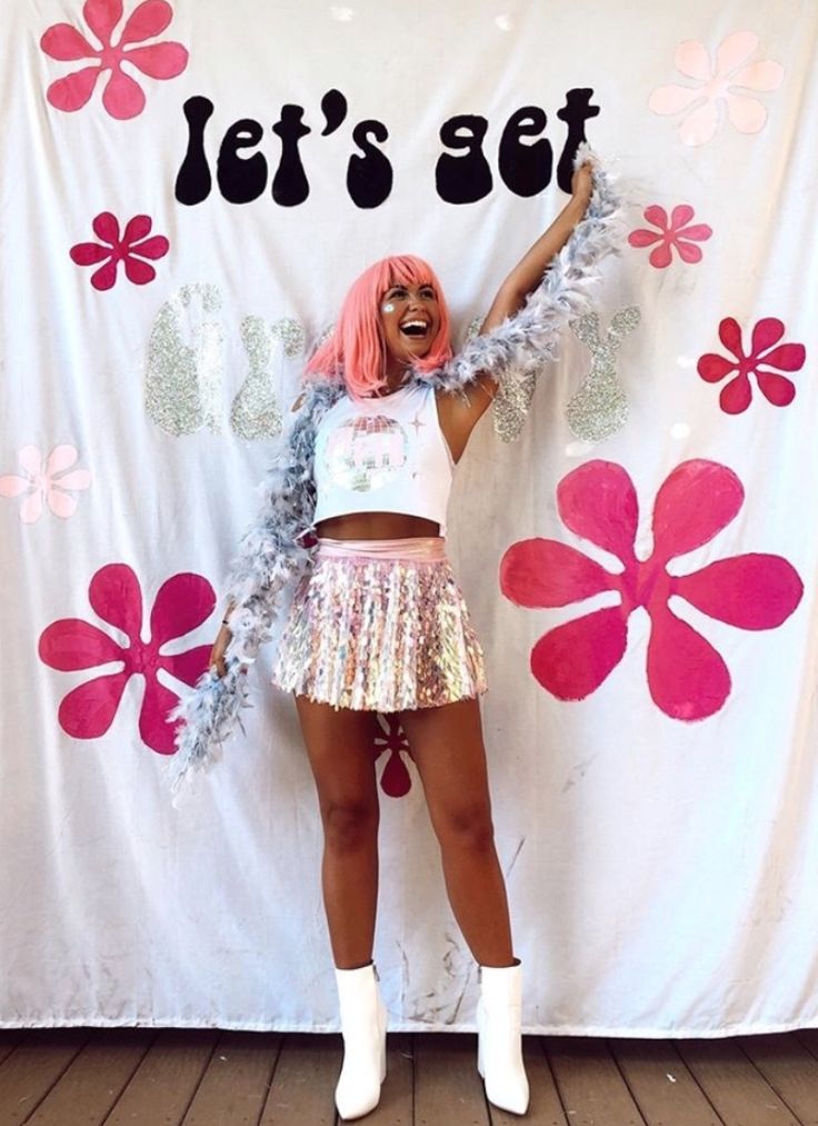 a woman with pink hair standing in front of a sign