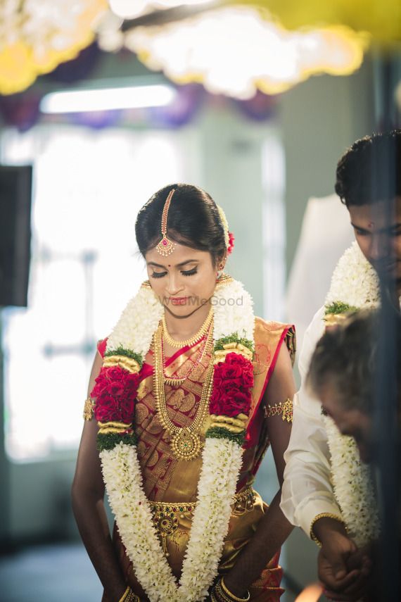 the bride is getting ready to walk down the aisle in her traditional wedding dress and jewelry