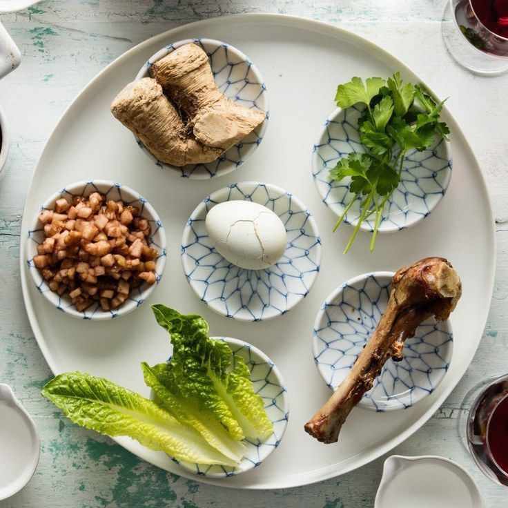 a white plate topped with different types of food next to cups and saucers on top of a table