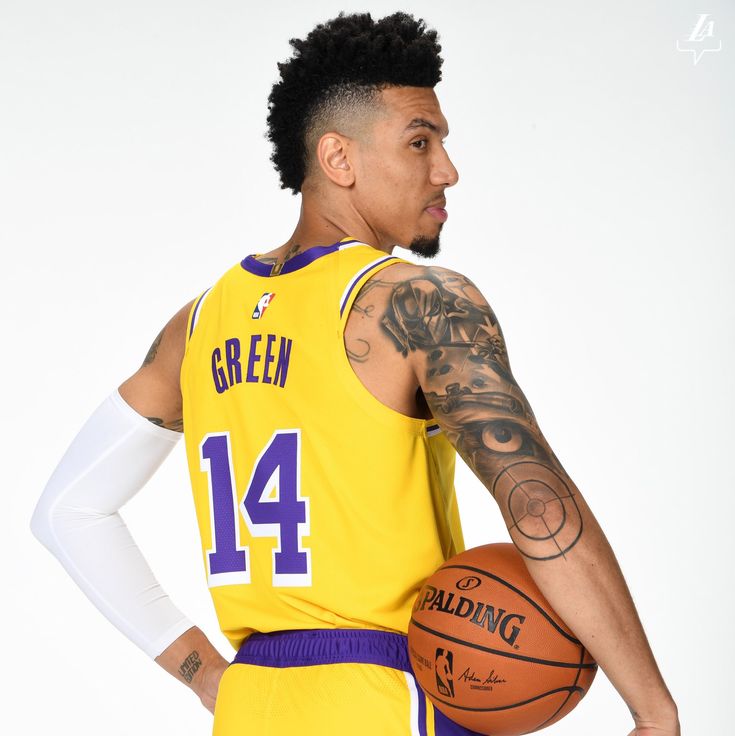 a man in a yellow uniform holding a basketball