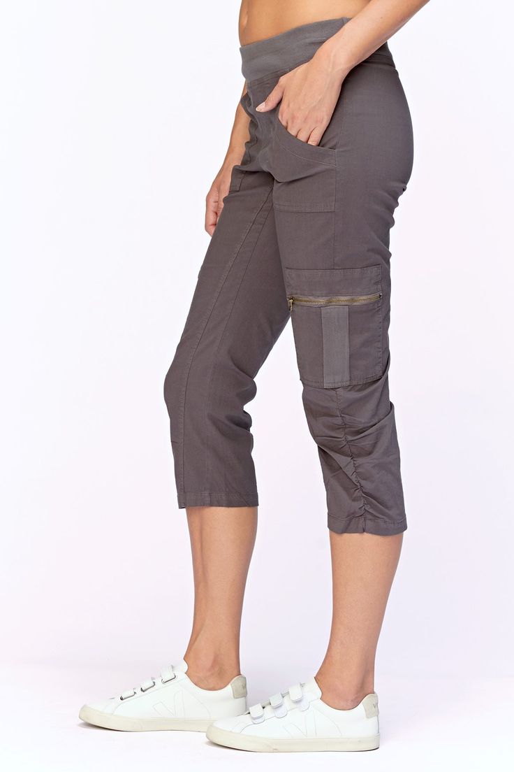 A stretch poplin crop with comfort & style. Features a pull on elastic waistband, two front pockets and two cargo zip pockets, clean back and style lines for added comfort. Stretch poplin body - 96/4 Cotton/Spandex 2x1 rib on waistband - 95/5 Cotton/Spandex Color description: Our favorite dark grey Waistband: 2" Elastic Inseam: 22" XS-XL Front rise: ~12" Back rise: ~20.5" 1X-3X Front rise: ~10" Back rise: ~15" Machine washable Preshrunk Imported MODELS Megan is wearing size X-Small Height: 5'10" | Bust: 34B | Waist: 25" | Hip: 34" Cropped Cargo Pants With Side Pockets For Fall, Fitted Versatile Cargo Pants With Hip Pockets, Versatile Fitted Cargo Pants With Hip Pockets, Utility Cargo Pants With Cropped Leg And Hip Pockets, Sporty Cargo Pants With Side Pockets For Work, Relaxed Fit Cropped Cargo Pants With Side Pockets, Capri Length Pants With Pockets For Work, Fitted Utility Cargo Parachute Pants, Casual Capri Length Cargo Pants