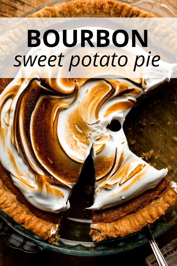 bourbon sweet potato pie on a wooden table with a slice missing from it and the text overlay reads bourbon sweet potato pie