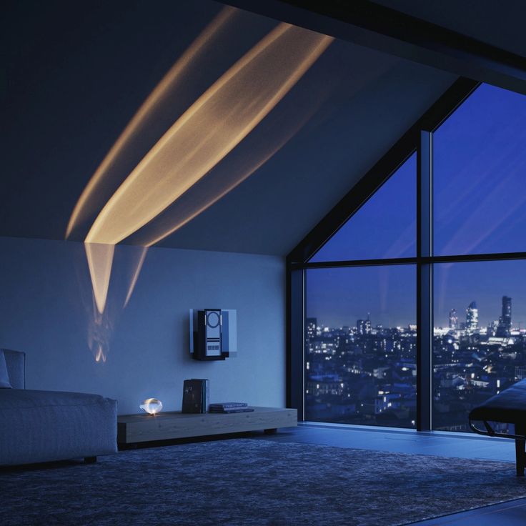 a bedroom with a large window overlooking the city lights at night and an area rug on the floor