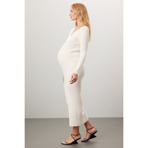 Off-white knit (48% Viscose, 27% Polyamide, 20% Polyester, 5% Wool). Sweater sheath. Long sleeves. V-neck. Pull on. 52" from shoulder to hemline. Imported. Cream Fitted V-neck Sweater Dress, White Stretch V-neck Sweater Dress, White V-neck Sweater Dress, Fitted V-neck Sweater Dress In Cream, Fitted V-neck Cream Sweater Dress, Cream V-neck Sweater Dress For Spring, White Stretch Sweater Dress With V-neck, White Knit Bodycon Sweater Dress, Chic White V-neck Sweater Dress