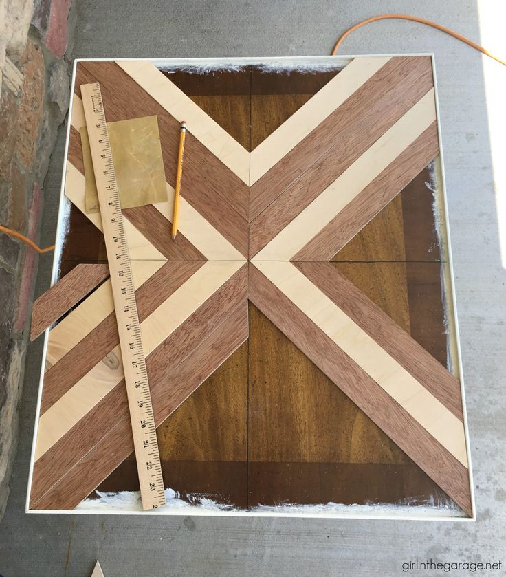 a piece of wood that has been cut into squares with a ruler and tape on it