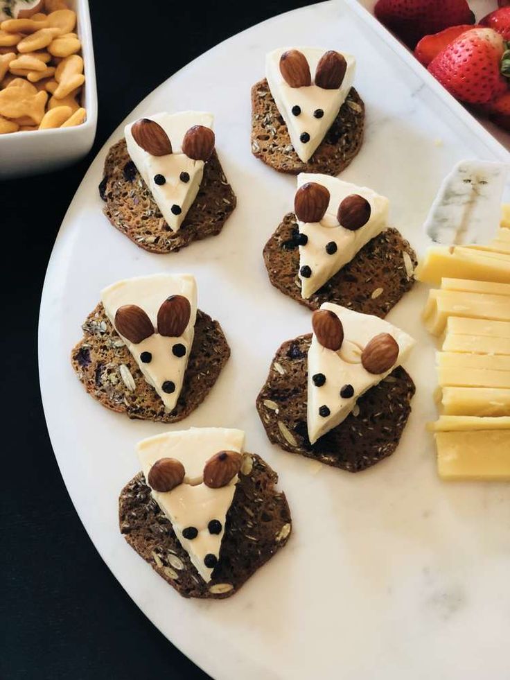 some crackers with cheese and nuts are on a plate