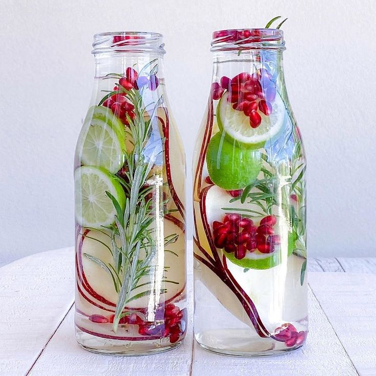 two glass jars filled with water and fruit