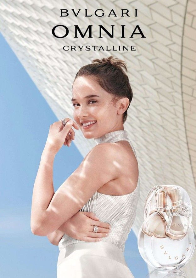 an advertisement for bvlgari omnia crystalline featuring a woman in white dress