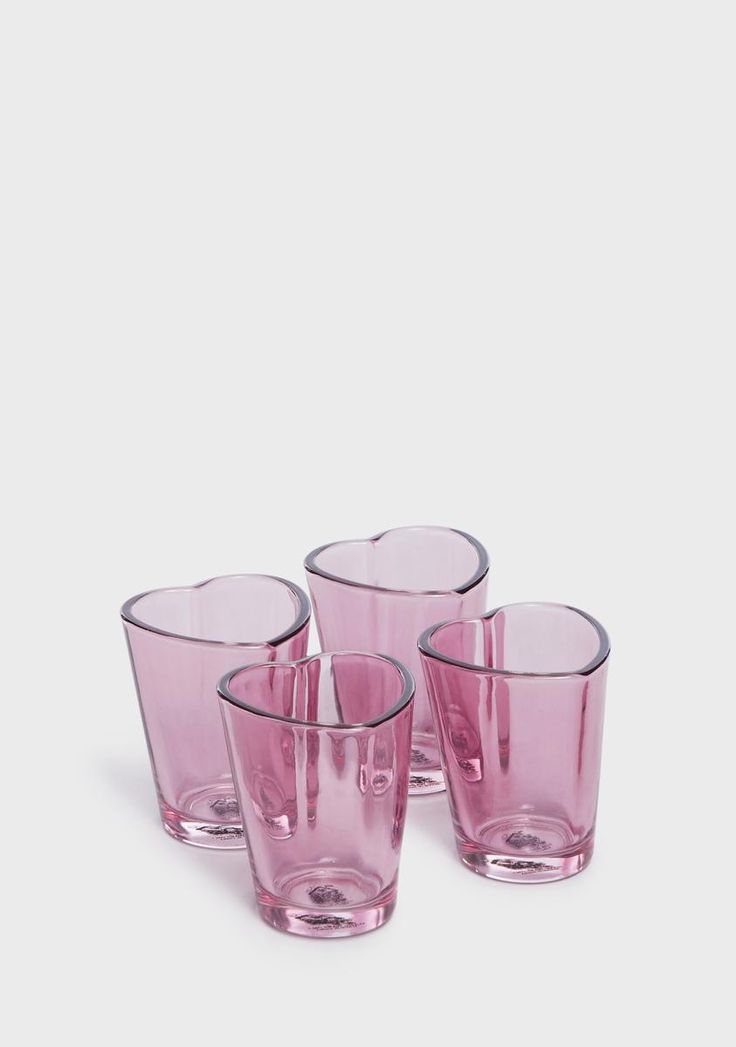 four pink glasses sitting next to each other