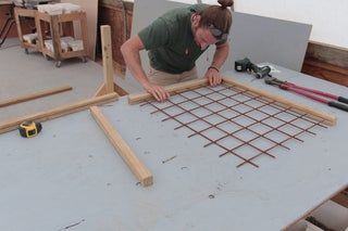 a woman is working on an unfinished floor