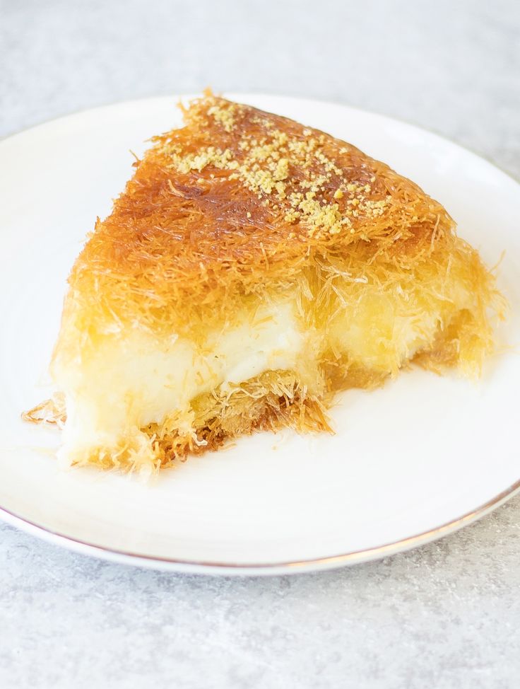 a piece of cake on a white plate with gold sprinkles and crumbs