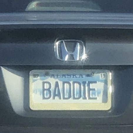 the back end of a car with a license plate that says baddie on it