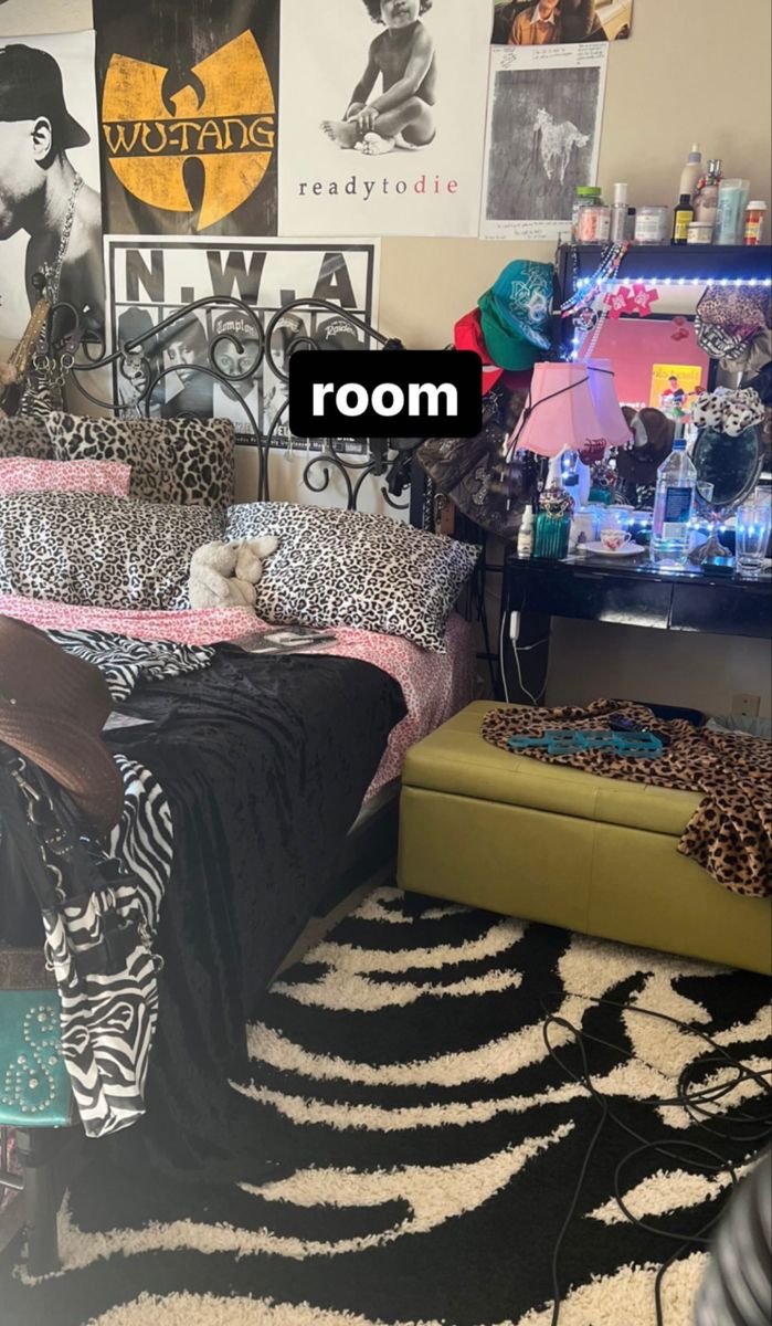 a bedroom with a zebra print rug and black and white bedding on the floor