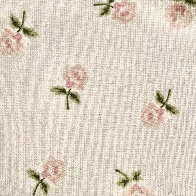 a white background with pink roses on it and green leaves in the middle, all over