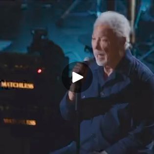 an older man sitting in front of a microphone