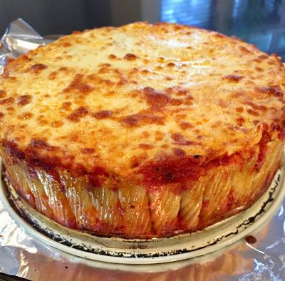 a cheese covered dish sitting on top of aluminum foil