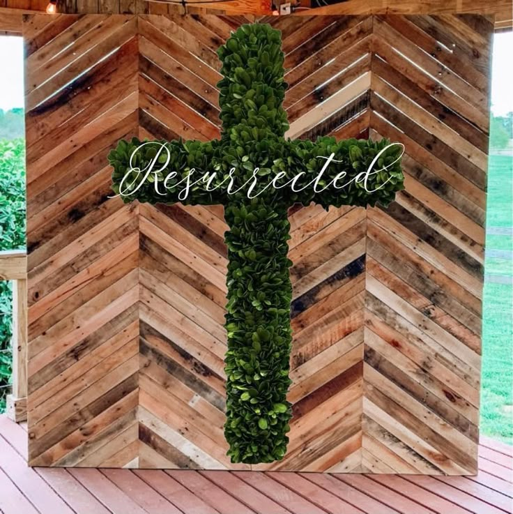 a cross made out of wood with the word reserved on it and surrounded by greenery