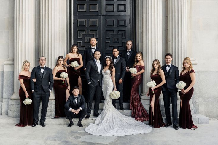 a group of people in formal wear posing for a photo