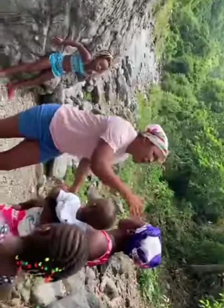 two women standing next to each other near a cliff