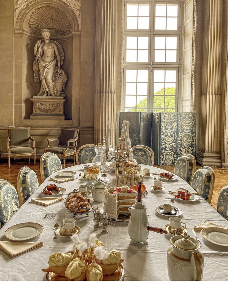 a dining room table is set with plates and silverware