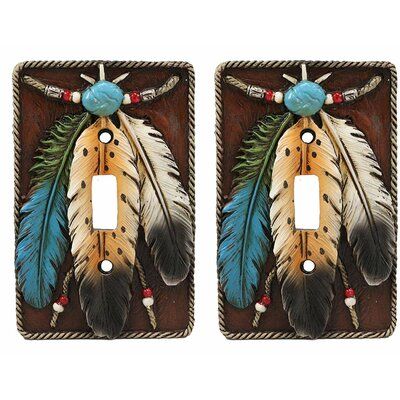 two light switch covers with feathers and beads on the front one has a blue bead