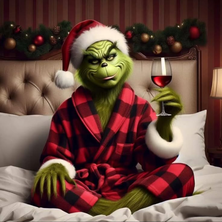 the grinch in pajamas is holding a glass of wine