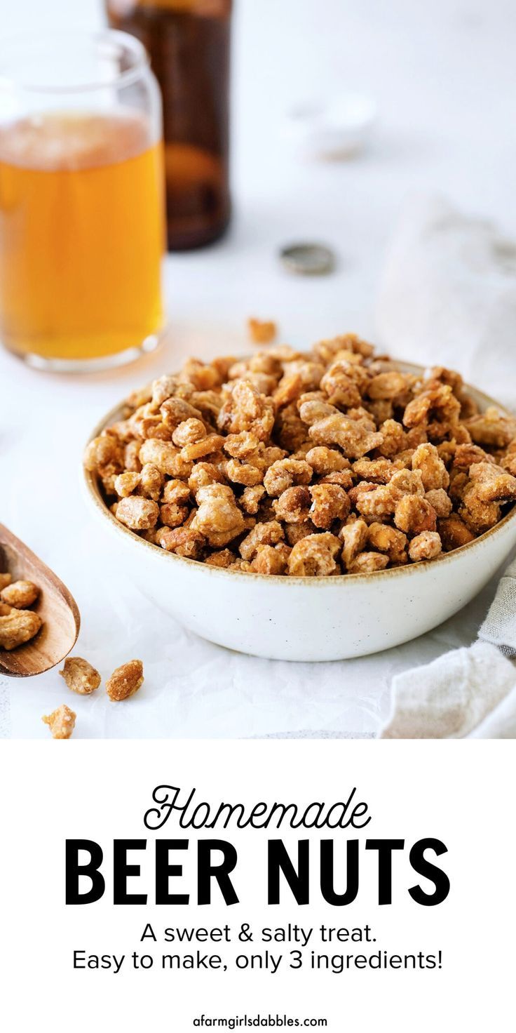 homemade beer nuts in a white bowl next to a glass of beer