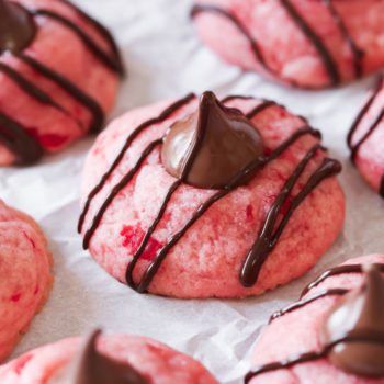 pink cookies with chocolate drizzled on them