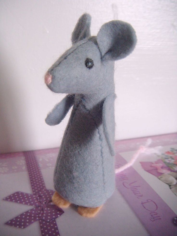 a stuffed mouse is standing on its hind legs