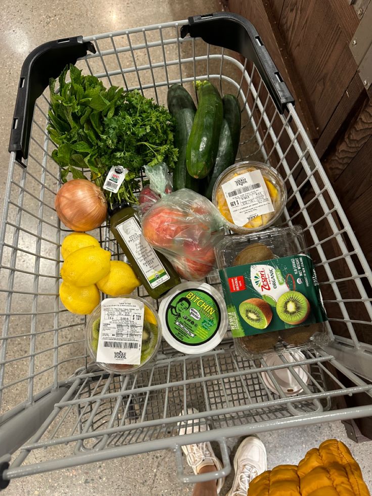 a shopping cart filled with assorted vegetables