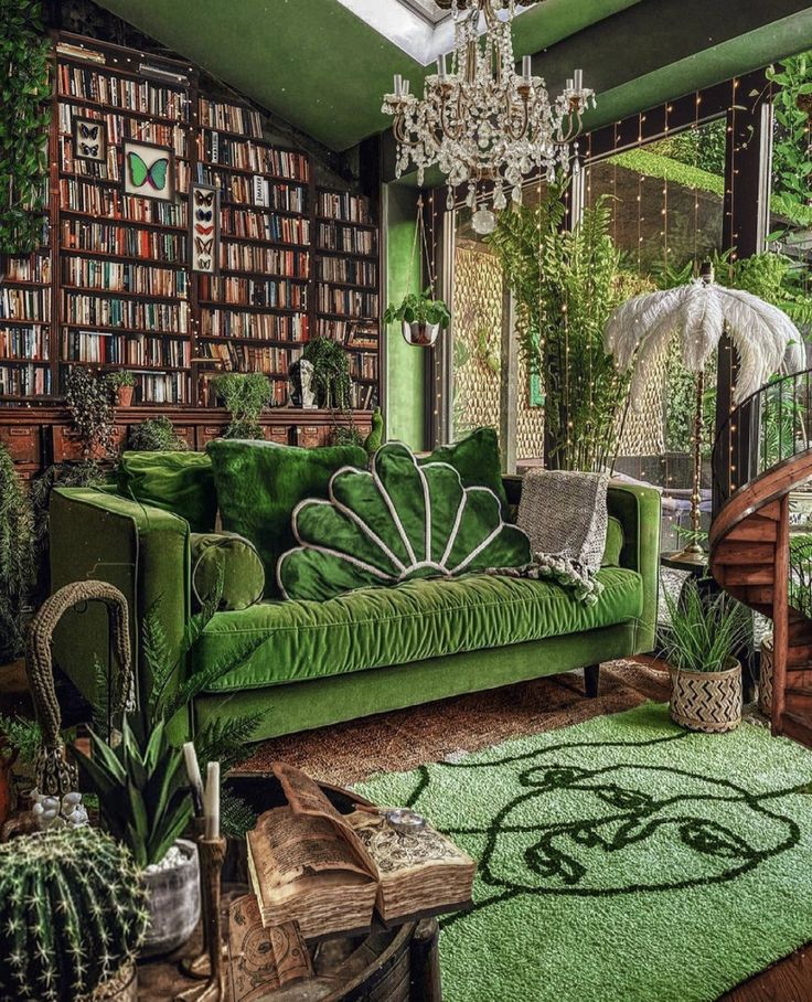 a green couch sitting in front of a book shelf filled with lots of books and plants