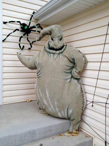 an inflatable costume is sitting on the steps with a large spider hanging from it's back