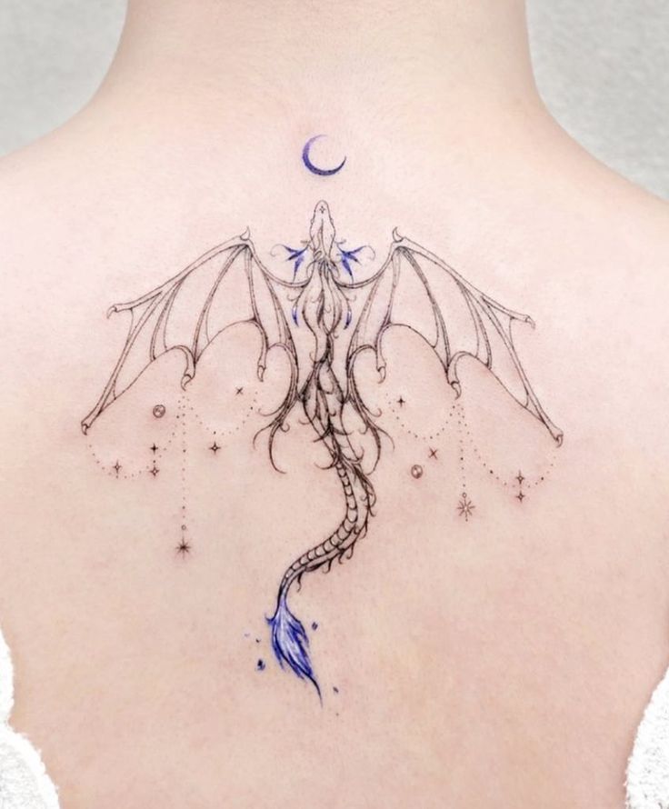 a woman with a dragon tattoo on her back