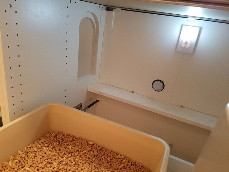 a large container filled with lots of food in a room next to a shelf and window