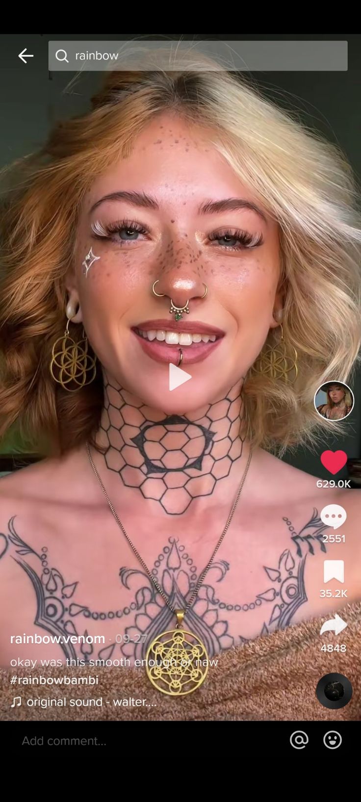 a woman with tattoos and piercings on her chest