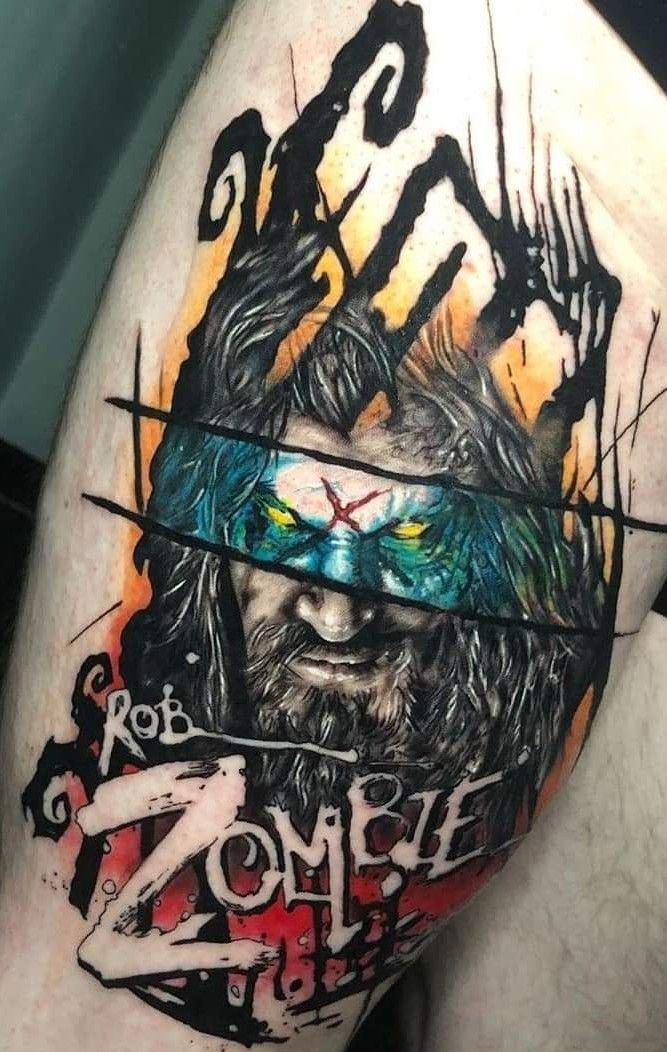 a man's thigh with an image of a demon on it and the words zombie zone